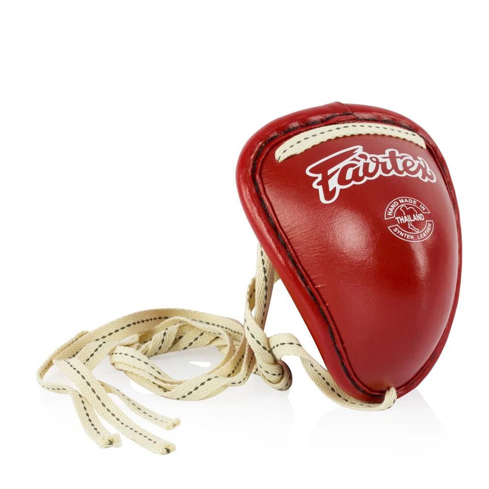 Steel groin guard by Fairtex angled view highlighting traditional design and compact protection--אדום